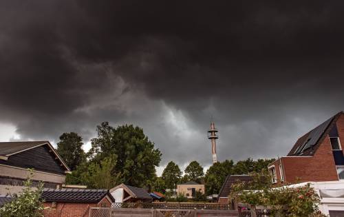 The clouds of a heavy thunderstorm darken the sky above Hoogezand. ANP GINOPRESS